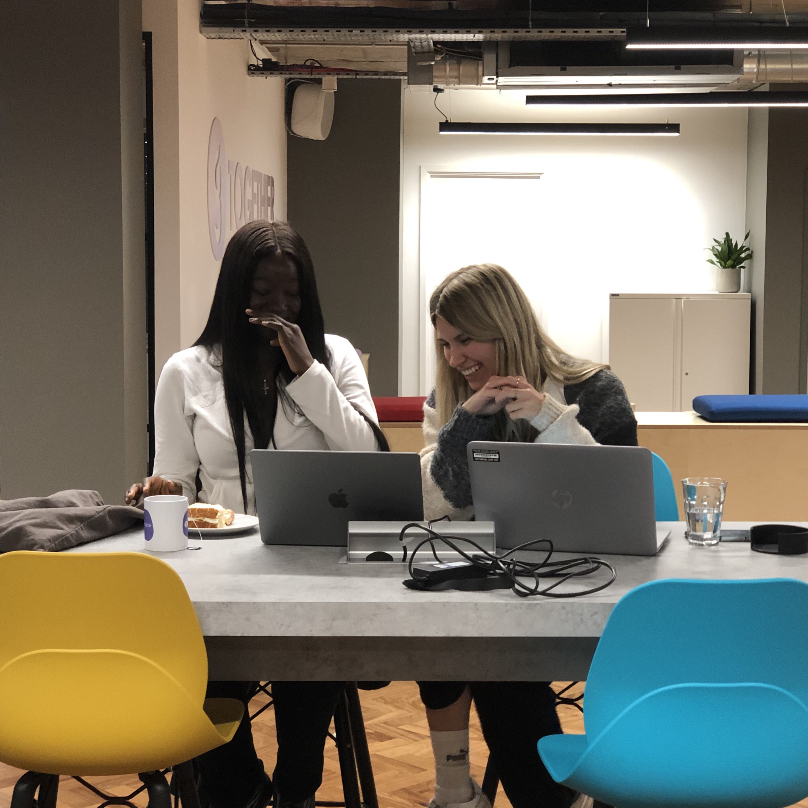Women laughing at a codebar workshop
